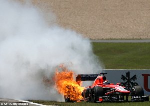 Bianchi's Marussia on fire just before it free-wheeled across the track