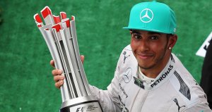 A happy Lewis Hamilton with his winner's trophy
